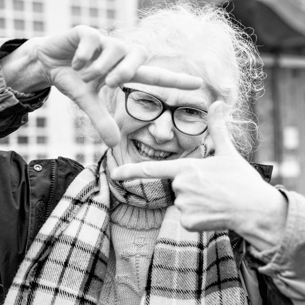 Designer Megan Fitzoliver makes a frame for her face by placing her hands into a rectangular shape.