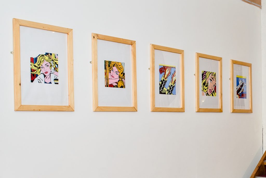 Lichtenstein style artworks on a gallery wall